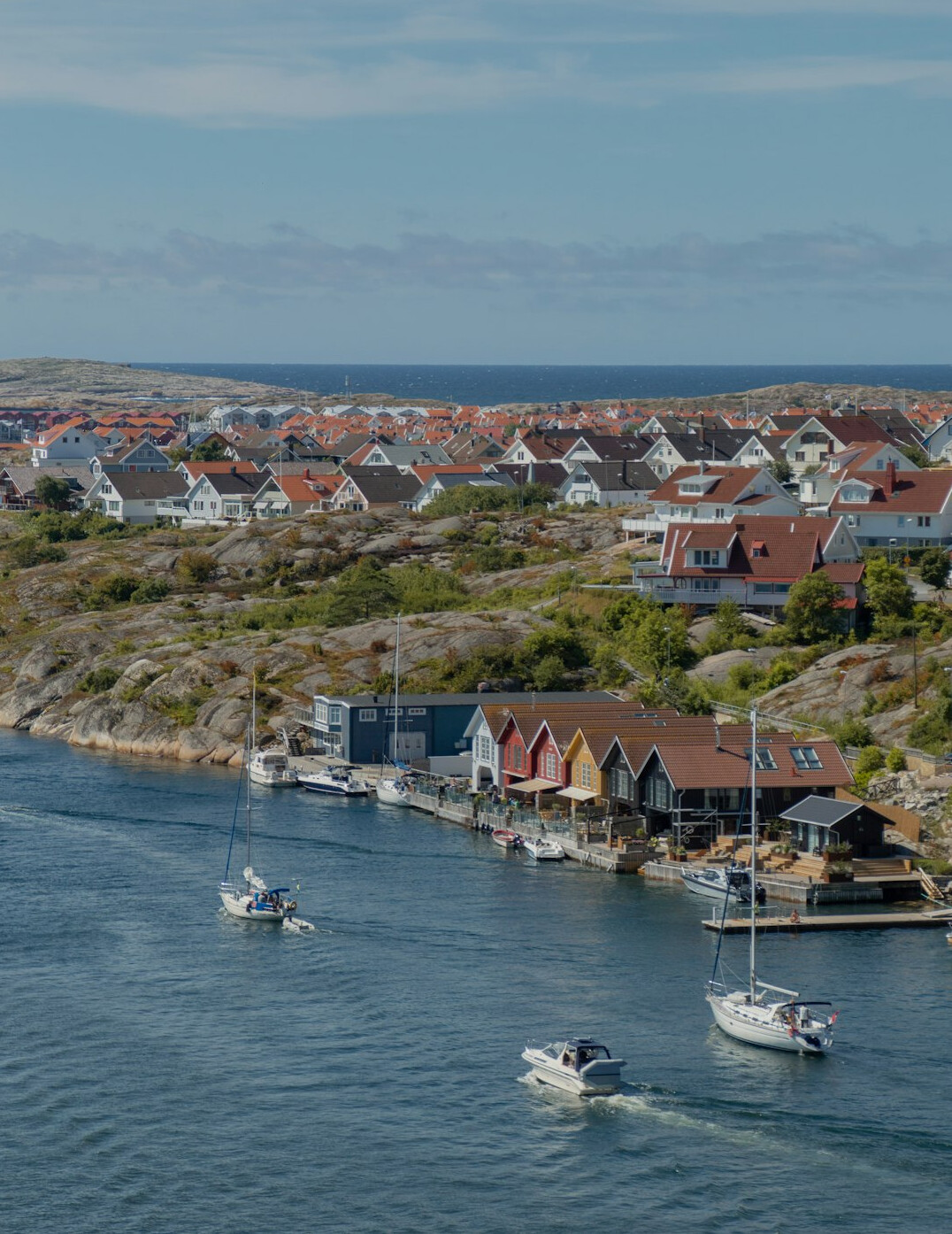 Small Danish coastal harbour community with houses and fishing boats